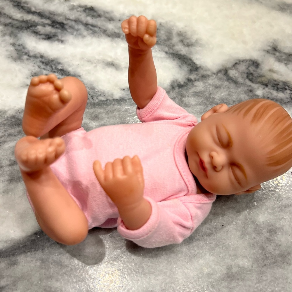 Poseable Pink Baby Doll with Realistic Design 10 inches.